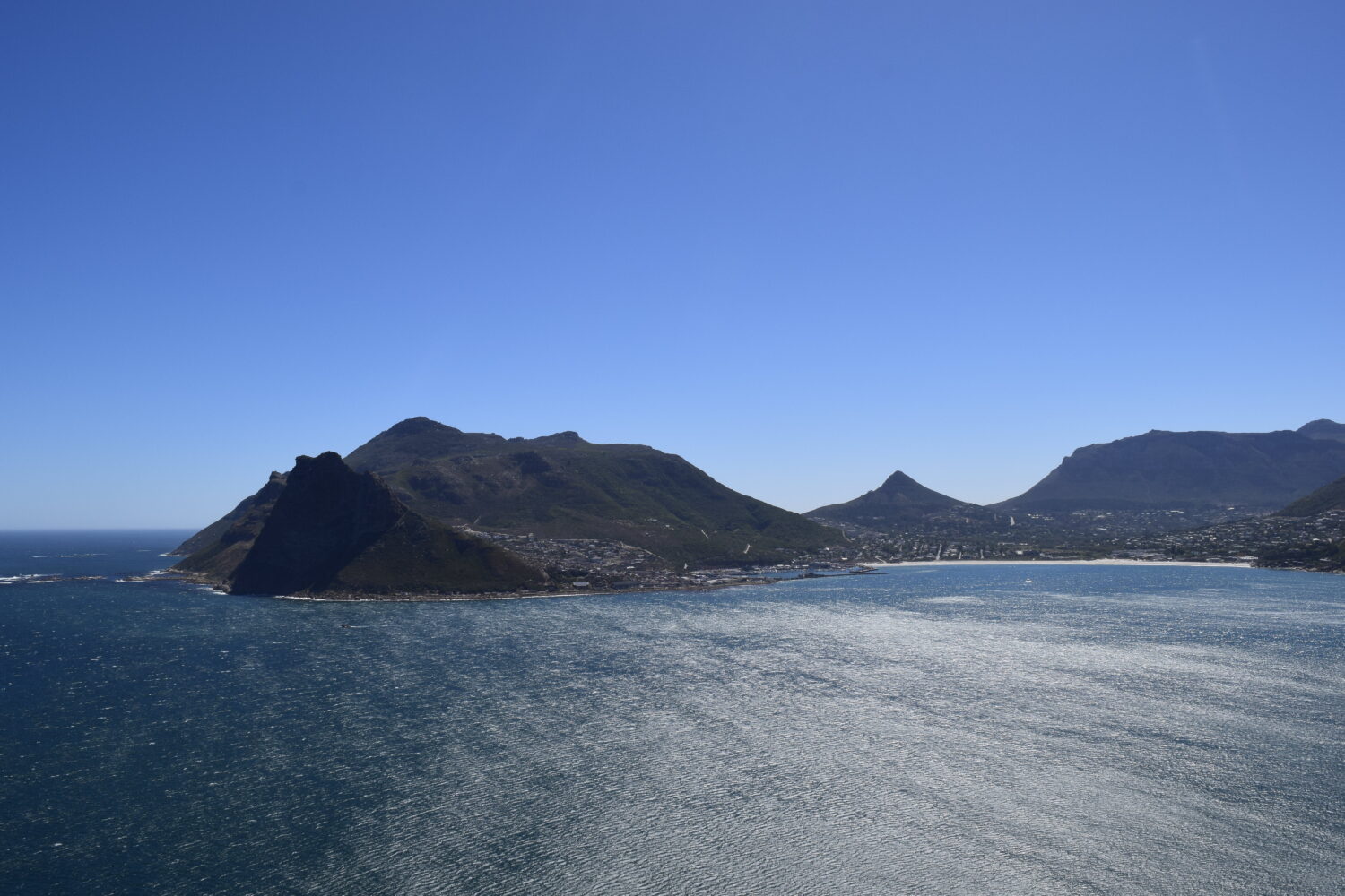 Panoramic view of Chapman's Peak Drive winding along the Atlantic coastline between Hout Bay and Noordhoek in Cape Town, South Africa.